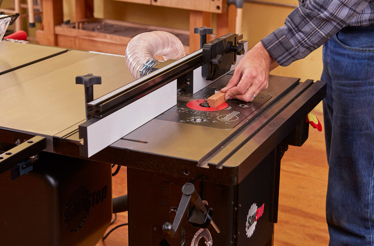 Person using a table saw in a workshop setting