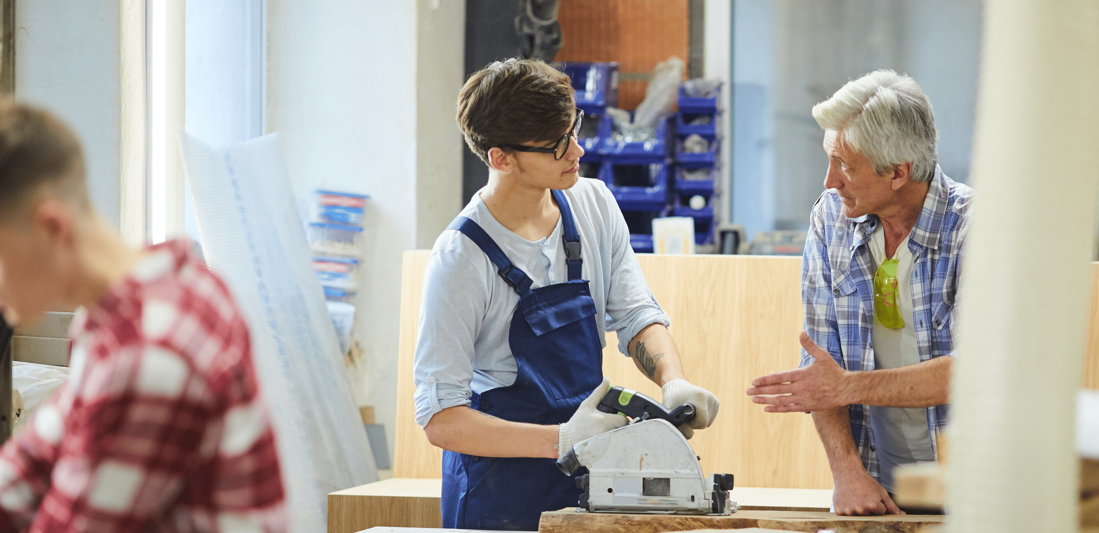 People working with tools in a workshop setting